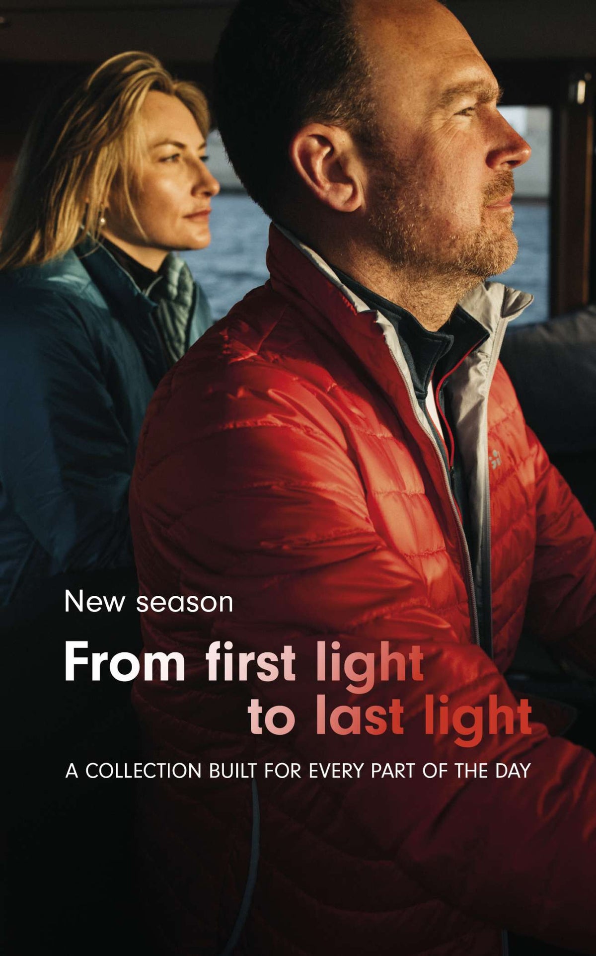 A promotional still from a collection titled 'From first light to last light' showing a man in a red puffer jacket in profile and a woman in a blue jacket in the background, with text overlay on a dark outdoor setting.